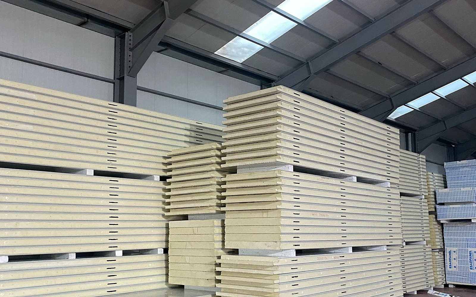 Insulated cold-room panels stacked in a plant (illustrative)