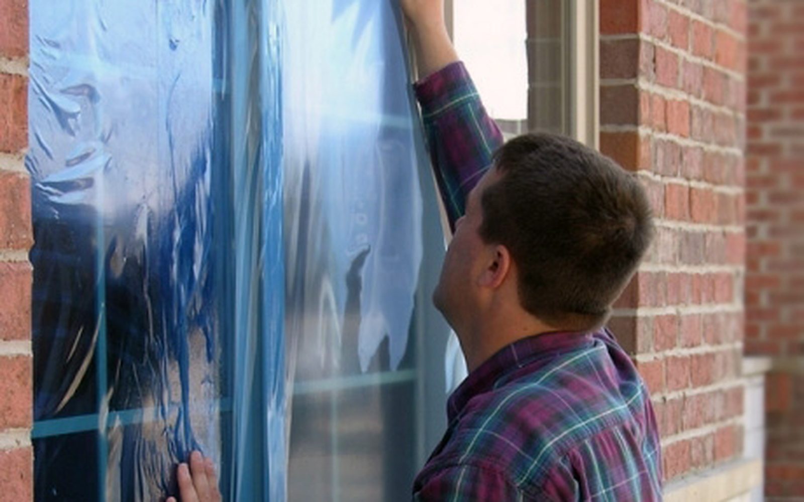 Protective film being applied to a window